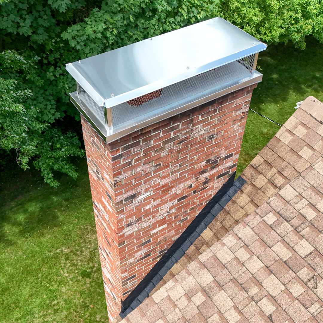 Durable stainless steel flue cap installed on a chimney